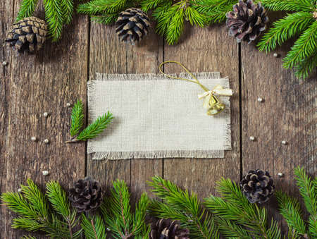card frame with fir branches with New Year's toys on a wooden backgroundの写真素材