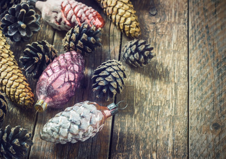 toys for the Christmas tree and pine cones on old wooden background.Christmas. Christmas time. Pine cones   Wooden background. toningの写真素材
