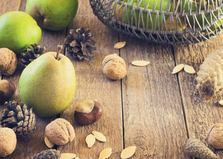Autumn composition of fruits, nuts and spices - pears, walnuts  on a wooden background toningの写真素材