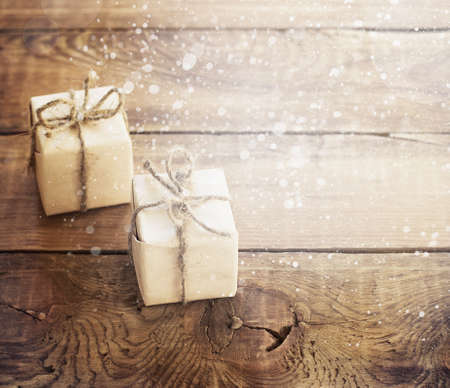 Christmas presents on dark wooden background in vintage style toningの写真素材