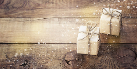 Christmas presents on dark wooden background in vintage style toningの写真素材