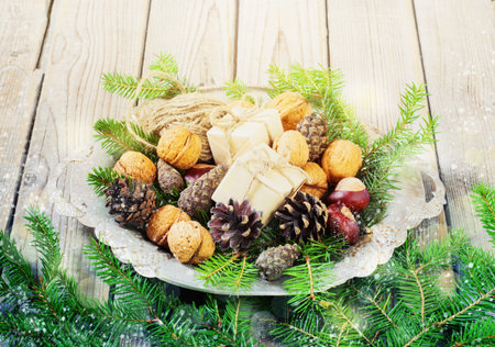 toys for the  tree   Christmas  new Year, gift, fir-tree, Walnut, pine cones in a metal bowl, on old wooden background. Christmas. Christmas time. Pine cones   Wooden background. toningの写真素材