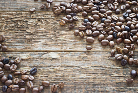Coffee beans on dark wooden background. Top view.