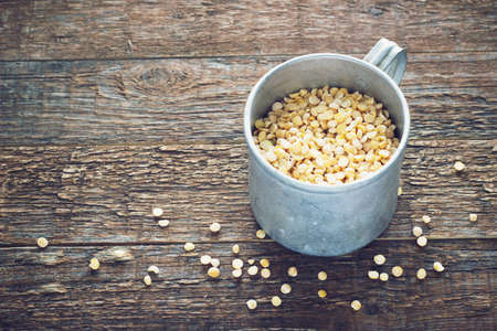 chick-pea a old metal mug on wooden background toningの写真素材