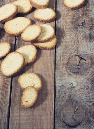 crackers on a dark wooden background view from above toningの写真素材