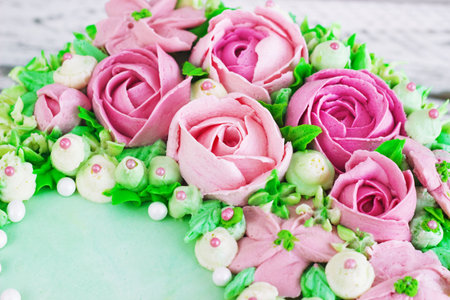 Birthday cake with flowers rose on white background.の写真素材