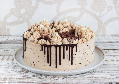 Chocolate cupcake with chocolate mousse cream icing on grunge white wooden background