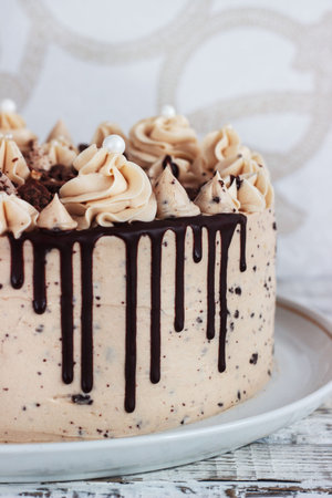 Chocolate cupcake with chocolate mousse cream icing on grunge white wooden background