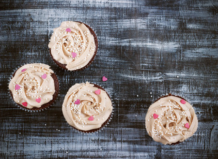 Chocolate cupcakes decorated with cream rose hearts