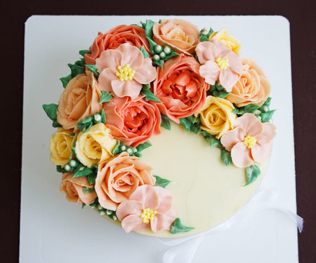 Birthday cake with flowers rose on white background.の写真素材