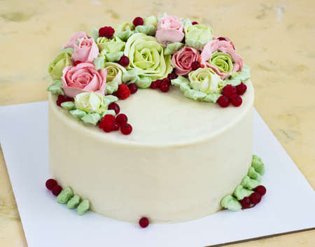 Birthday cake with flowers rose on light backgroundの写真素材