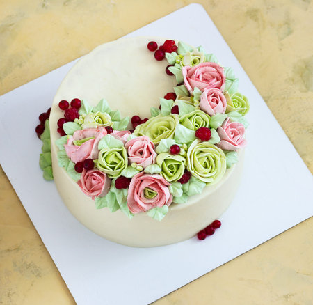 Birthday cake with flowers rose on light background.