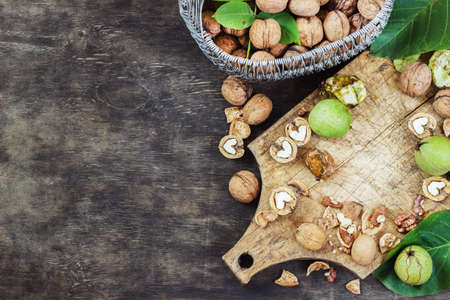 Whole Walnuts and Cleared Black Wooden Background Top view Healthy conceptの写真素材