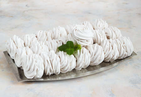 apple marshmallows in a metal bowl on a light backgroundの写真素材