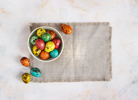 Colored easter eggs on a light canvas background,place for text.