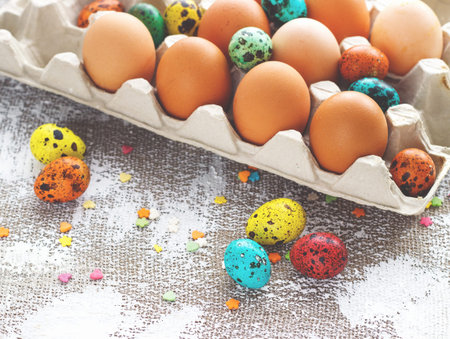 Colored easter eggs on a light canvas background,place for text.