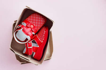 Children's shoes on a pink backgroundの写真素材