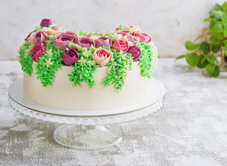 Birthday cake with flowers rose on white backgroundの写真素材