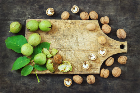 Whole Walnuts and Cleared Black Wooden Background Top view Healthy concept