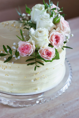 Beautiful Wedding cake with flowers on marble table and white background