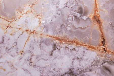 Texture of walls with cracks and scratches. Gold marble pattern. Background image of the stone surface. An old and worn-out wall. It can be used for interior-exterior home decorの写真素材