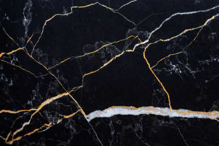 black marble with Golden lines, natural black marble texture. White and yellow patterned natural details in dark gray marble. Textured background for interior or product designの写真素材