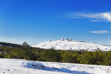 Radar station and other buildings on the top of mount Ai-Petri, Yalta Municipality, Crimea, Russia. Snow, frosted trees in sunny winter day.の写真素材