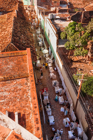 Colonial town cityscape of Trinidad, Cuba. Street shopping. Many little street shops sell linen and cotton clothes and accessories. のeditorial素材