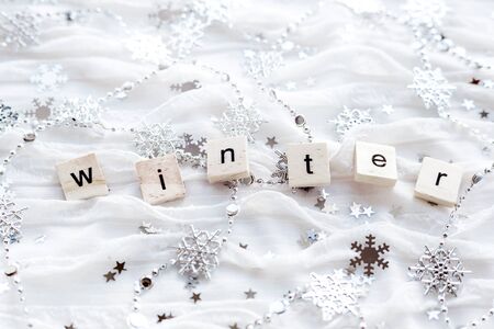 Winter background with decorative sparkling snowflakes and word WINTER.の写真素材