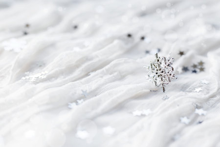 White holiday background with sparkling silver snowflakes, christmas decorations.