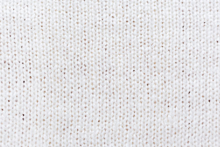 Abstract knitted background. Wool white sweater texture, close up.