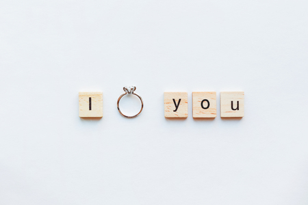 White background with wooden words I LOVE YOU and diamond engagement ring. Good as card or background for Valentine's Day of engagement card.の写真素材