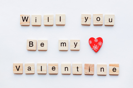 White background with wooden words and red heart, symbol of love. Good as card or background for Valentine's Day.の写真素材