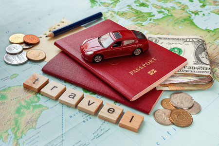 Travel background with passport, money, map and notes. Word TRAVEL and symbol of car travel - car model.の写真素材