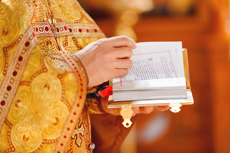 Prayer book in the hands of the priest. Ceremony in the Orthodox Christian Church. Russia.の写真素材