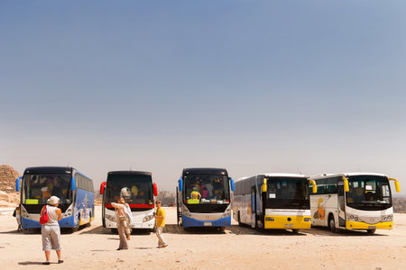 GIZA, EGYPT - September 11, 2008. Tourists stay near pyramides of Giza and touristic buses.のeditorial素材