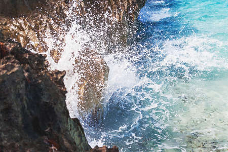 Sea waves beat against the rocky shore. Water flooded depressions in the rocks. Varadero, Cuba.の写真素材