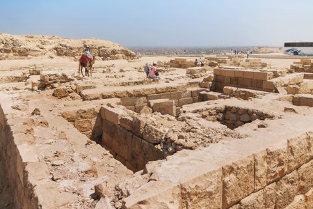 GIZA, EGYPT - September 11, 2008. Tourists are walking around the Great pyramid of Giza and excavations near it. UNESCO World Heritage Site.のeditorial素材