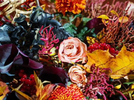 Bright autumn bouquet with peach colored roses, black Calla lilies, red Dahlia and berries.の写真素材