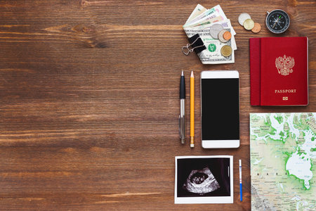 Travel while being pregnant background. Different things you need for journey - smartphone,...