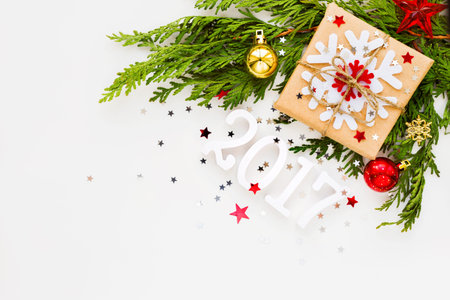 Christmas and New Year 2017 background with thuja branch, decorations and present wrapped in craft...