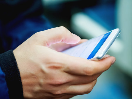 Man holds a smartphone in hand. 