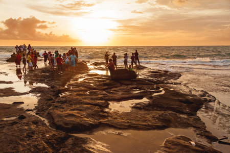 TANAH LOT, INDONESIA - January 22, 2013. People meet sunset on the coast near the Tanah Lot temple.のeditorial素材