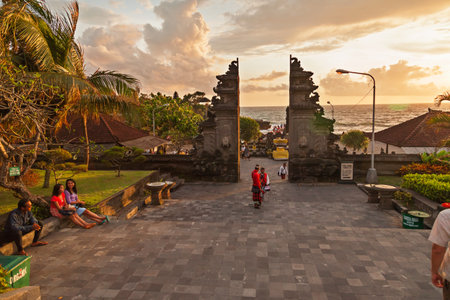 TANAH LOT, INDONESIA - January 22, 2013. People near entrance to the temple complex of Tanah Lot.のeditorial素材
