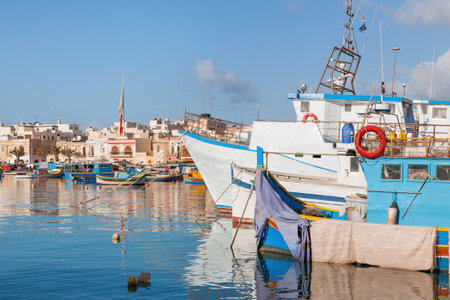 Mediterranean traditional colorful boats luzzu. Fisherman village in the south east of Malta. Early winter morning in Marsaxlokk, Malta.のeditorial素材