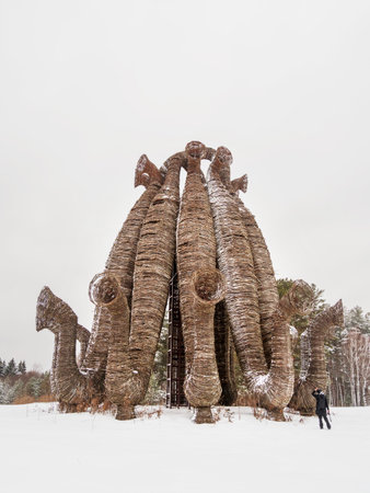 NIKOLA-LENIVETS, RUSSIA - January 15, 2017. Tourist near artobject "BEAUBOURG" by Nikolay Polissky. Wooden object in winter forest.のeditorial素材