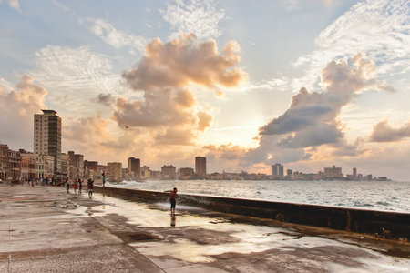 HAVANA, CUBA - February 10, 2008. People meet sunset after storm at famous embankment promenade Malecon.のeditorial素材