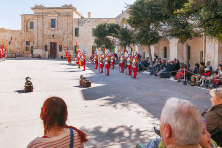 VALLETTA, MALTA - February 21, 2010 - Knights of the Order of St. John during reenactment. Tourists watch the performance from from the fenced places.のeditorial素材