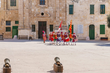 VALLETTA, MALTA - February 21, 2010 - Knights of the Order of St. John during reenactment. Tourists watch the performance from from the fenced places.のeditorial素材