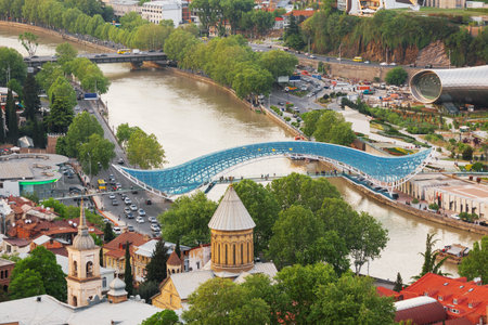 Panorama aerial view on modern landmark - Bridge of Peace over Kura river. Tbilisi, Georgia.のeditorial素材